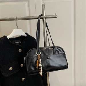 Classic black high-shine bowling handbag with beaded tassel and slim handles