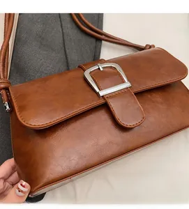 Close-up of a brown vintage baguette bag with a textured finish and silver square buckle
