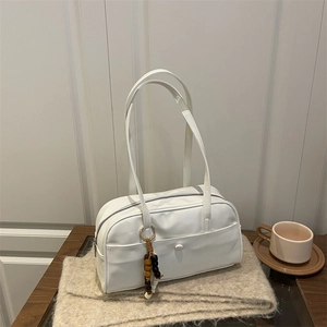 White faux leather minimalist bowling handbag with wooden bead charm on wool scarf
