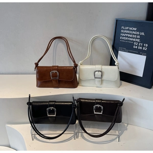 Detail view of four vintage baguette bags in brown, white, black and dark coffee PU leather