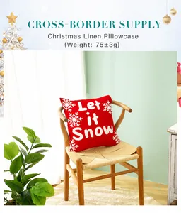Detail of red Christmas pillowcase with white snowflakes and Let it Snow script