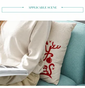 Detail of Christmas reindeer cushion cover shown on a sofa in a cozy home setting