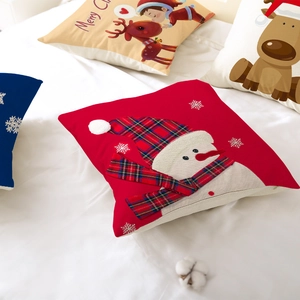 Housses de coussin de Noël dessin animé avec renne et bonhomme de neige sur un lit