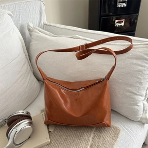 Fashionable brown large capacity hobo tote bag for women shown in a cozy home setting