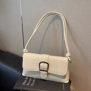 French style creamy white baguette bag with silver horseshoe buckle and knotted strap