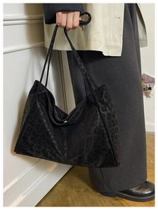 Close-up of black leopard print tote bag with premium matte texture and dual handles