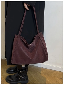 Detail of dark red leopard jacquard tote bag with long shoulder straps for underarm wear