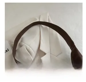 Detail showing the wide leather shoulder strap on a brown leopard tote shopping bag