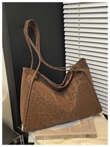 Close-up of vintage leopard print tote bag with soft leather texture in a stylish setting