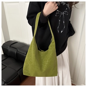 Detail of green leopard print hobo tote bag featuring subtle textured animal pattern