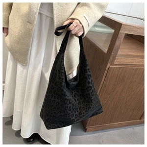 Detail of grey leopard print tote bag showing wide shoulder strap and soft fabric texture