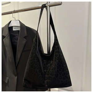 Close-up of leopard print tote bag featuring high-capacity design and plush texture