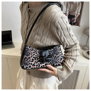 Detail der Leopard-Achseltasche mit glänzender Lackklappe und Schleifenverschluss