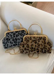 Detail of leopard print kiss-lock bags with gold metal handles and chain straps