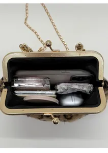 Detail view of leopard print plush bag interior with gold metal frame and chain