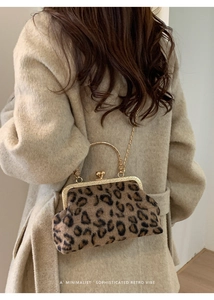 Detail of leopard print faux fur clutch bag with gold frame closure and chain strap