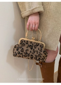 Detail of leopard print faux fur bag with retro gold clasp handle and chain strap