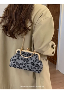 Detail of grey leopard faux fur bag with vintage metal frame and gold chain strap