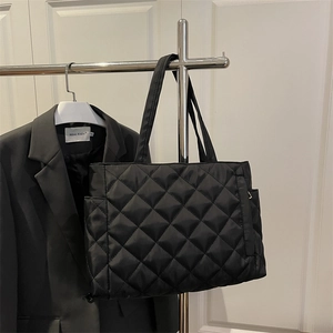 Black quilted tote bag with diamond pattern and large capacity for daily commuting