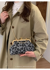 Detail of faux fur leopard print bag featuring a gold kiss-lock and chain strap