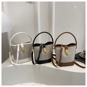 Detailed comparison of three color-blocked canvas bucket bags in black, white, and brown