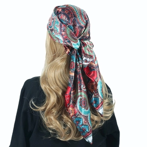 Detailed back view of a satin square scarf with vintage paisley print tied as a headscarf