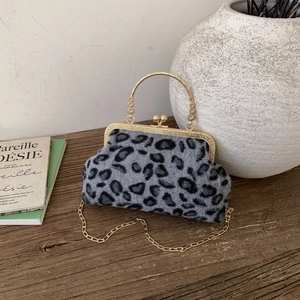 Vintage leopard print plush handbag with gold metal frame and delicate chain strap