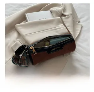 Internal capacity of contrast cylinder bag showing phone storage and suede detail