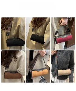 Detail of cylinder bags in five colors featuring ethnic style wide woven shoulder straps