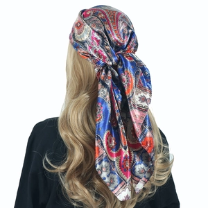Detail of 90cm paisley satin scarf tied as a bohemian headband on blonde hair