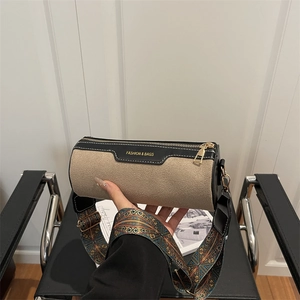 Fashionable khaki and black cylinder crossbody bag with vintage patterned wide strap