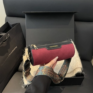 Burgundy suede cylinder bag with vintage patterned strap and fashion lettering