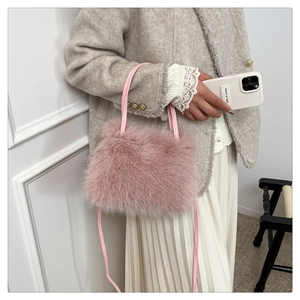 Close-up of pink faux fur texture on handbag with thin leather straps and shoulder strap