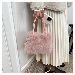 Fashionable pink faux fur handbag showing high-quality texture and soft shoulder strap