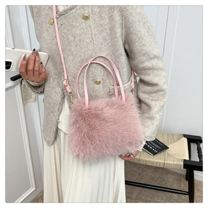 Detail of pink faux fur handbag showing plush texture and adjustable leather strap
