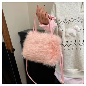 Close-up of pink faux fur handbag with soft plush texture and leather shoulder strap