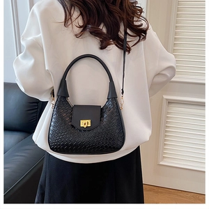Detailed back view of a black woven crescent bag with gold chain and rectangle clasp
