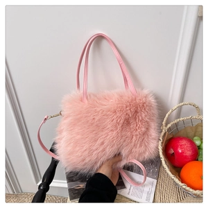 Detail of pink faux fur handbag with leather handles and detachable shoulder strap