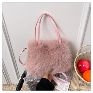 Detail of pink faux fur handbag with leather handle and adjustable shoulder strap