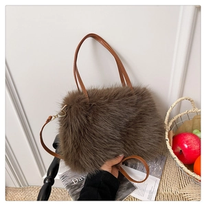 Close-up of plush brown faux fur texture and adjustable leather strap with gold buckle