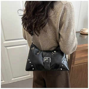 Close-up of black rivet hobo bag showing silver stud details and belt buckle design