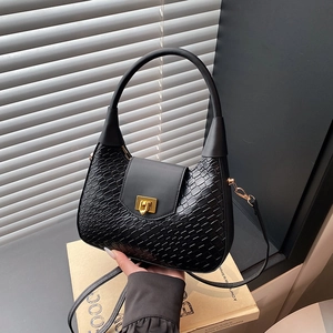 Large black woven crescent shoulder bag with golden lock and adjustable strap