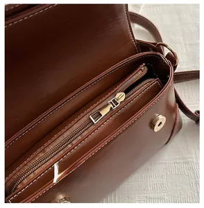 Detail of retro shoulder bag interior with smooth zipper and magnetic closure