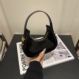 Glossy black patent leather crescent hobo bag with gold zipper and curved top handle