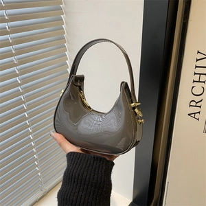 Dark grey patent leather crescent hobo bag with glossy finish and gold-tone zipper