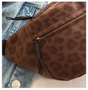 Detail shot of smooth black zipper on leopard print crossbody waist bag