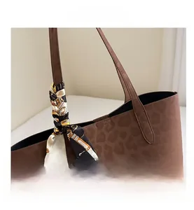 Detailed view of the leopard print tote bag with a decorative silk scarf and handle