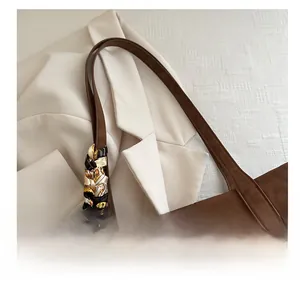 Close-up of caramel brown tote bag handle with stylish leopard print silk scarf detail