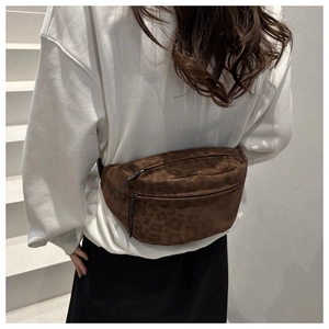 Close-up of stylish leopard print waist bag with double zippers worn by a model