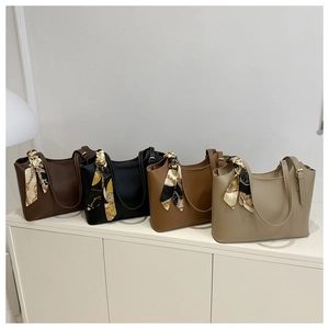 Row of faux leather tote bags in four colors with decorative vintage print silk scarves